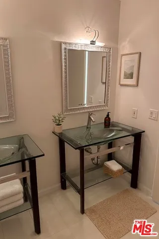 a view of a bathroom with sinks and mirror