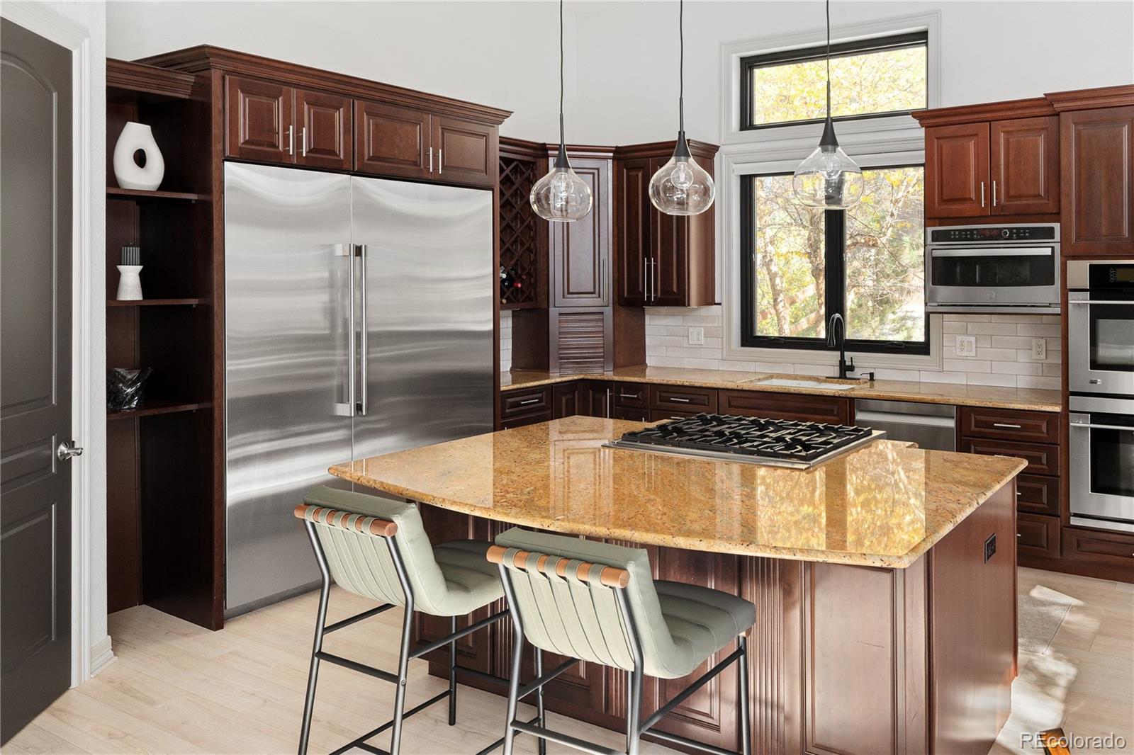 20132 East Shady Ridge Road Parker, CO 80134 - Photo 16 of 50 a kitchen with a table chairs and a refrigerator