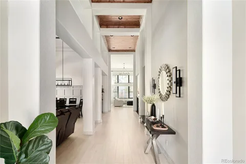 a view of a hallway with furniture and a potted plant