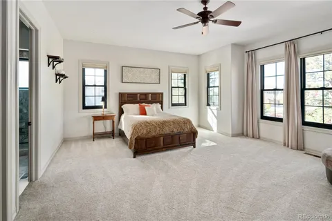 a bedroom with a bed a window and closet