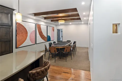 a view of dining room and livingroom with furniture wooden floor and a rug
