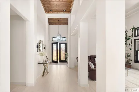 a view of a hallway with a white walls and a window