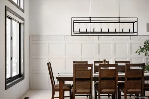 a view of a dining room with furniture and window