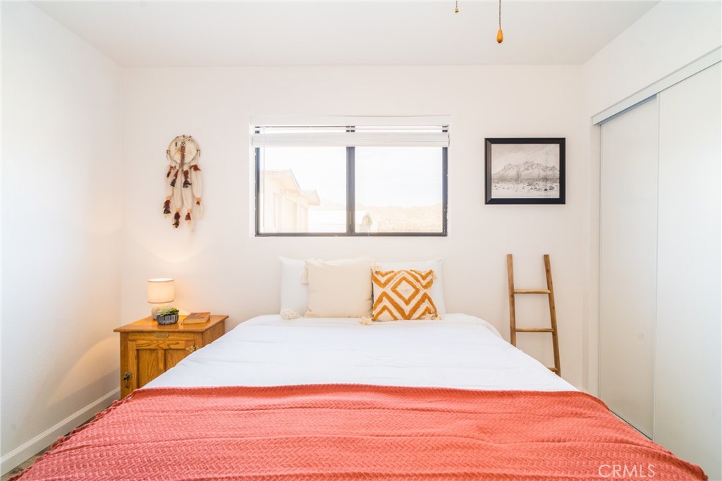 61191 Wilson Terrace Joshua Tree, CA 92252 - Photo 15 of 29 a bedroom with a bed and a window