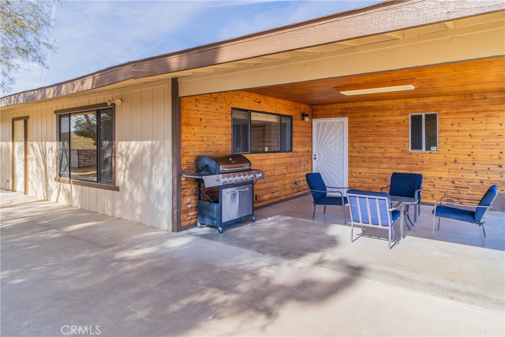 61191 Wilson Terrace Joshua Tree, CA 92252 - Photo 27 of 29 a patio with table and chairs and potted plants