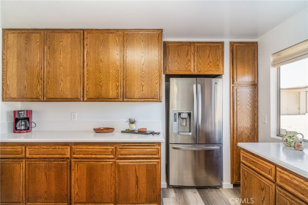 61191 Wilson Terrace Joshua Tree, CA 92252 - Photo 4 of 29 a kitchen with stainless steel appliances granite countertop a refrigerator and a sink