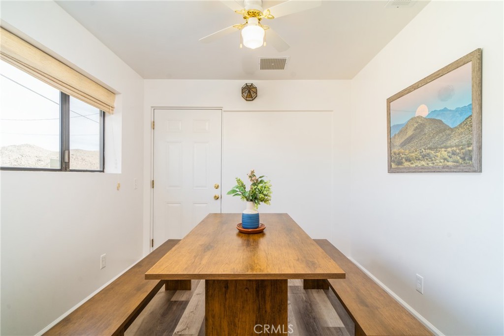 61191 Wilson Terrace Joshua Tree, CA 92252 - Photo 6 of 29 a view of a dining room with furniture and wooden floor