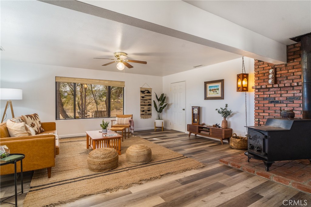 61191 Wilson Terrace Joshua Tree, CA 92252 - Photo 7 of 29 a living room with fireplace furniture and a large window