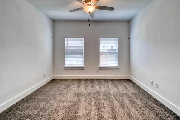 a view of room with window and ceiling fan