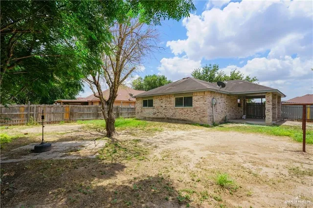 a backyard of a house with barbeque oven