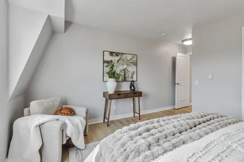 a bedroom with a bed and a table