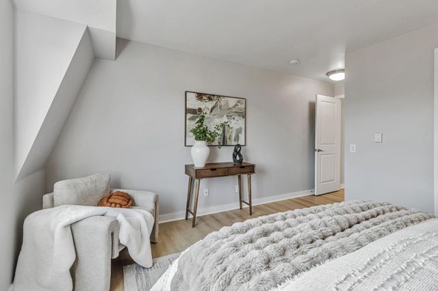 a bedroom with a bed and a table