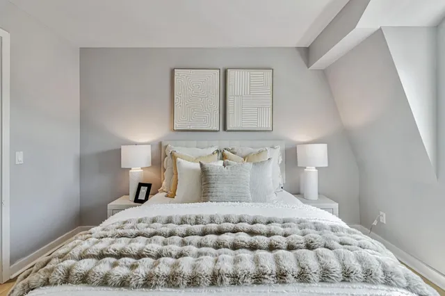 a bedroom with a bed and a night stand