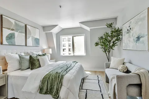 a bedroom with a bed and a window