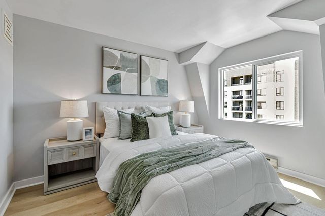 a bedroom with bed and a window