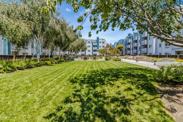 a view of yard with swimming pool and green space