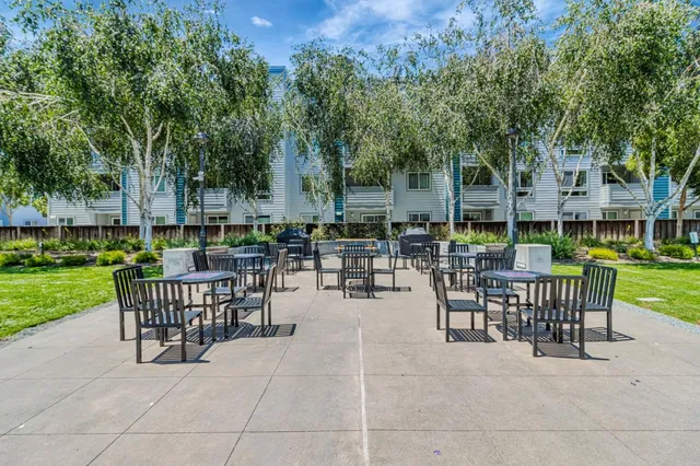 a view of a patio with dining table and chairs