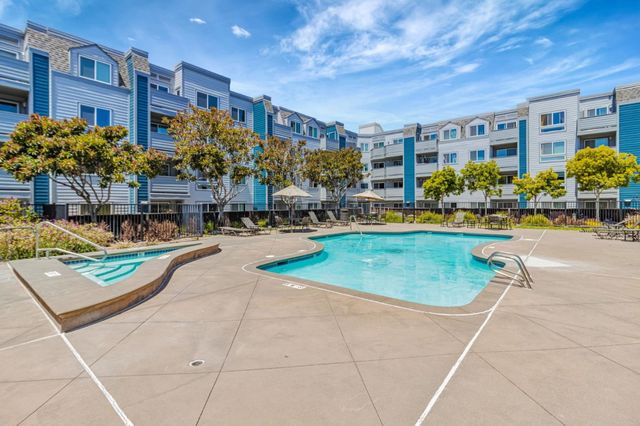 a swimming pool view with a outdoor seating
