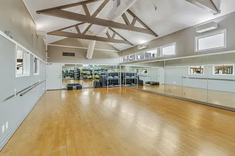 a view of a room with lots of wooden furniture
