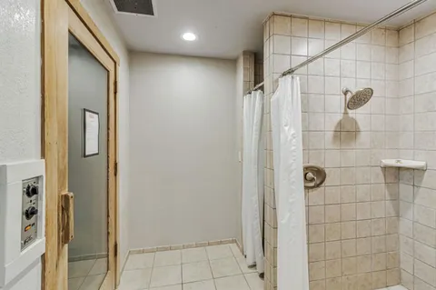 a bathroom with a shower and a glass door