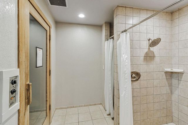 a bathroom with a shower and a glass door