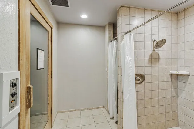 a bathroom with a shower and a glass door