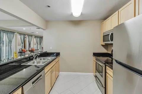 a kitchen with a sink and a refrigerator