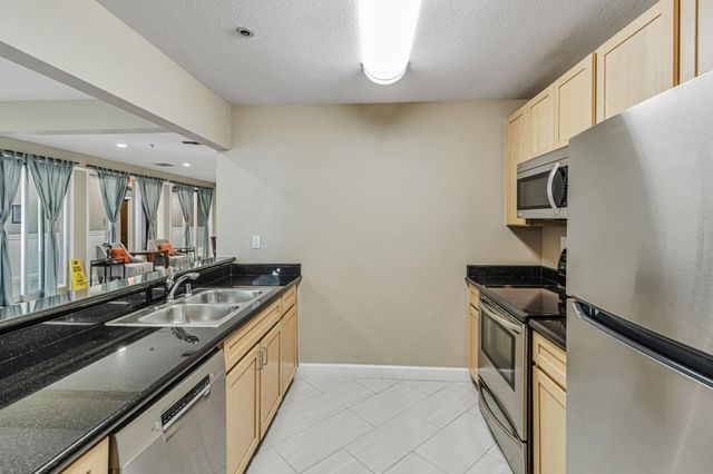 a kitchen with a sink and a refrigerator