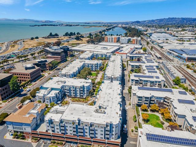 an aerial view of an ocean and houses