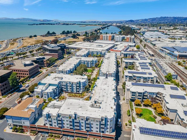 an aerial view of an ocean and houses
