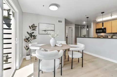 a dining room with furniture and window