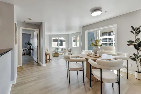 a dining room with furniture and wooden floor