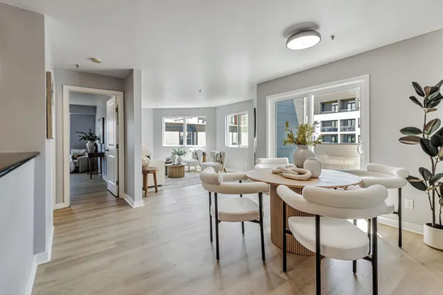 a dining room with furniture and wooden floor