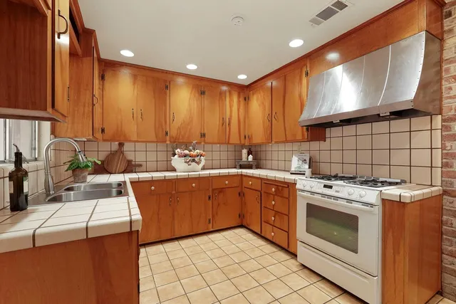 a kitchen with stainless steel appliances granite countertop a sink and cabinets