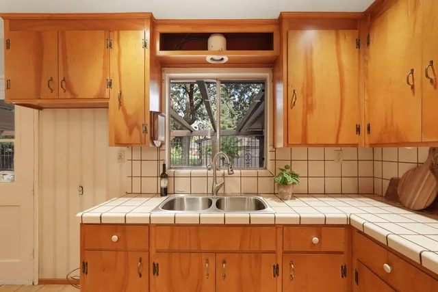 a kitchen with stainless steel appliances granite countertop a sink and cabinets