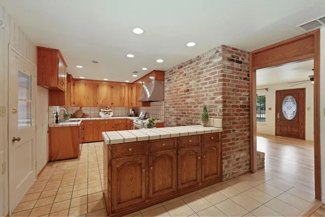 a view of a hallway with wooden floor and furniture