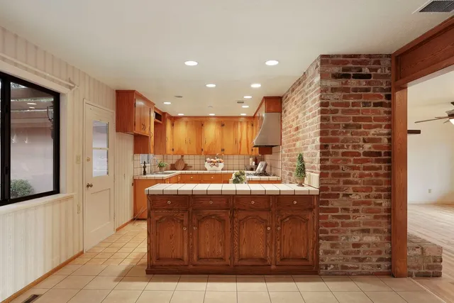 a view of a room with wooden floor and furniture