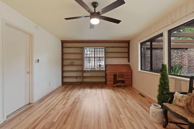 a view of a room with wooden floor