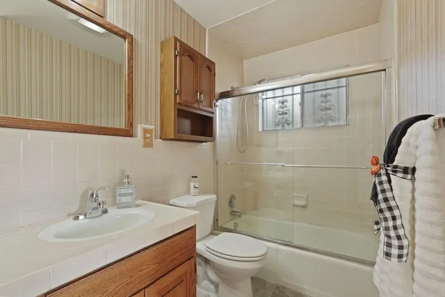 a living room with a large bed and chandelier