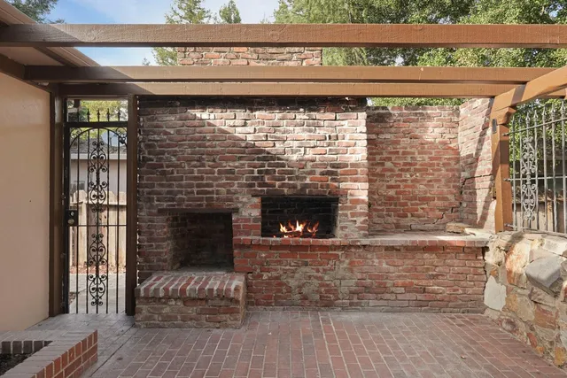 a front view of a house with a yard and trees