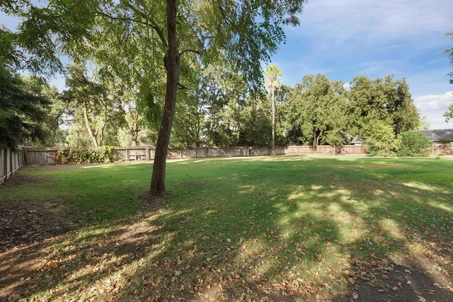 an aerial view of a house with a yard and garden