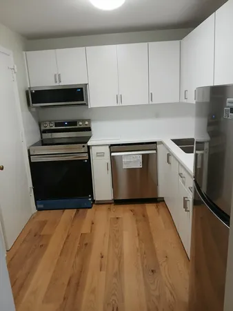a kitchen with a sink appliances and cabinets