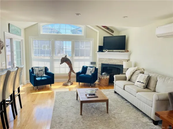 a living room with furniture fireplace and flat screen tv