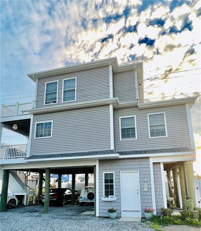 28 Beach Road West Old Saybrook, CT 06475 - Photo 8 of 22 a front view of a house with garden