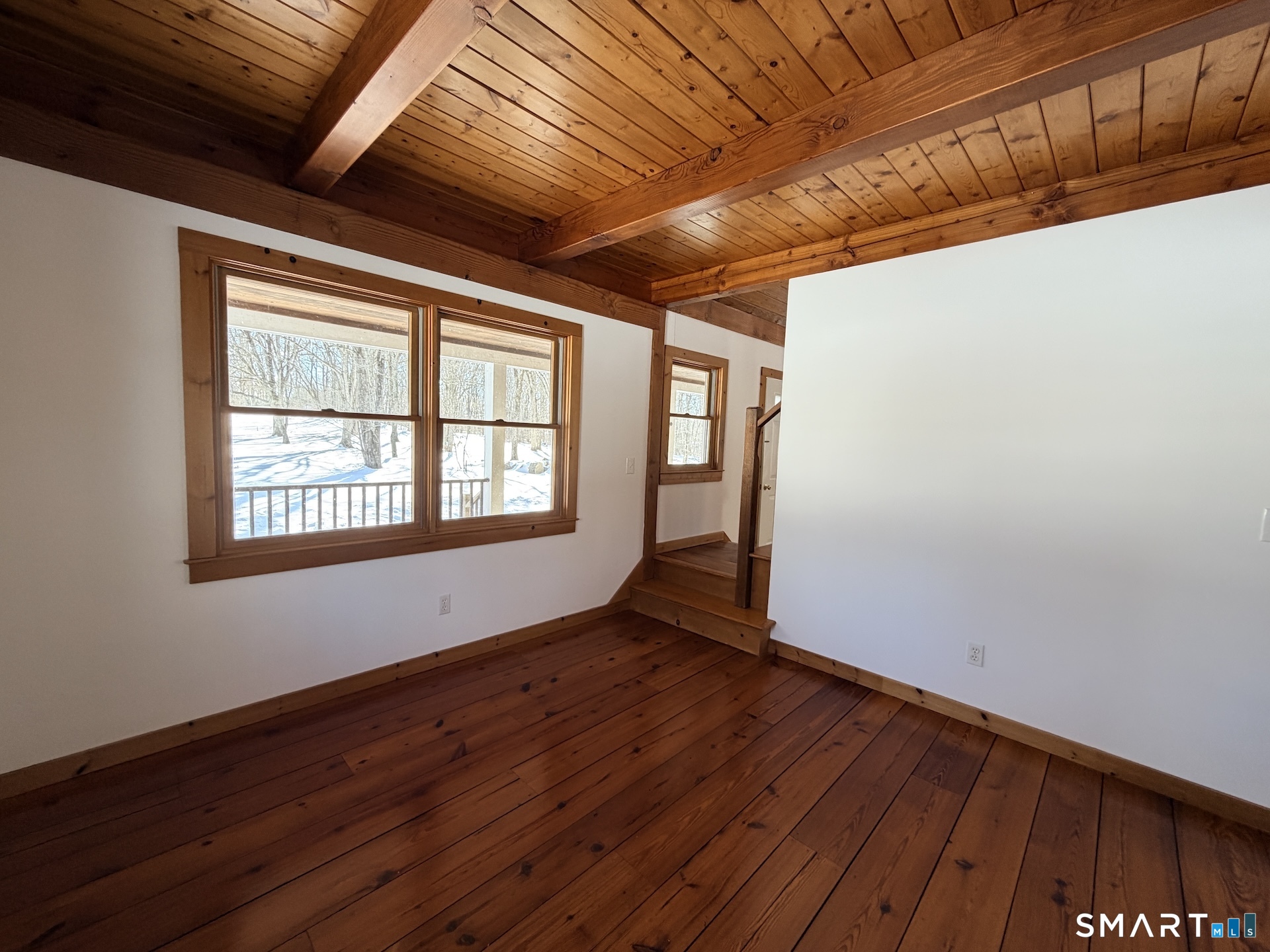 249 Woodbury Road Washington, CT 06793 - Photo 11 of 23 a view of an empty room with wooden floor and a window