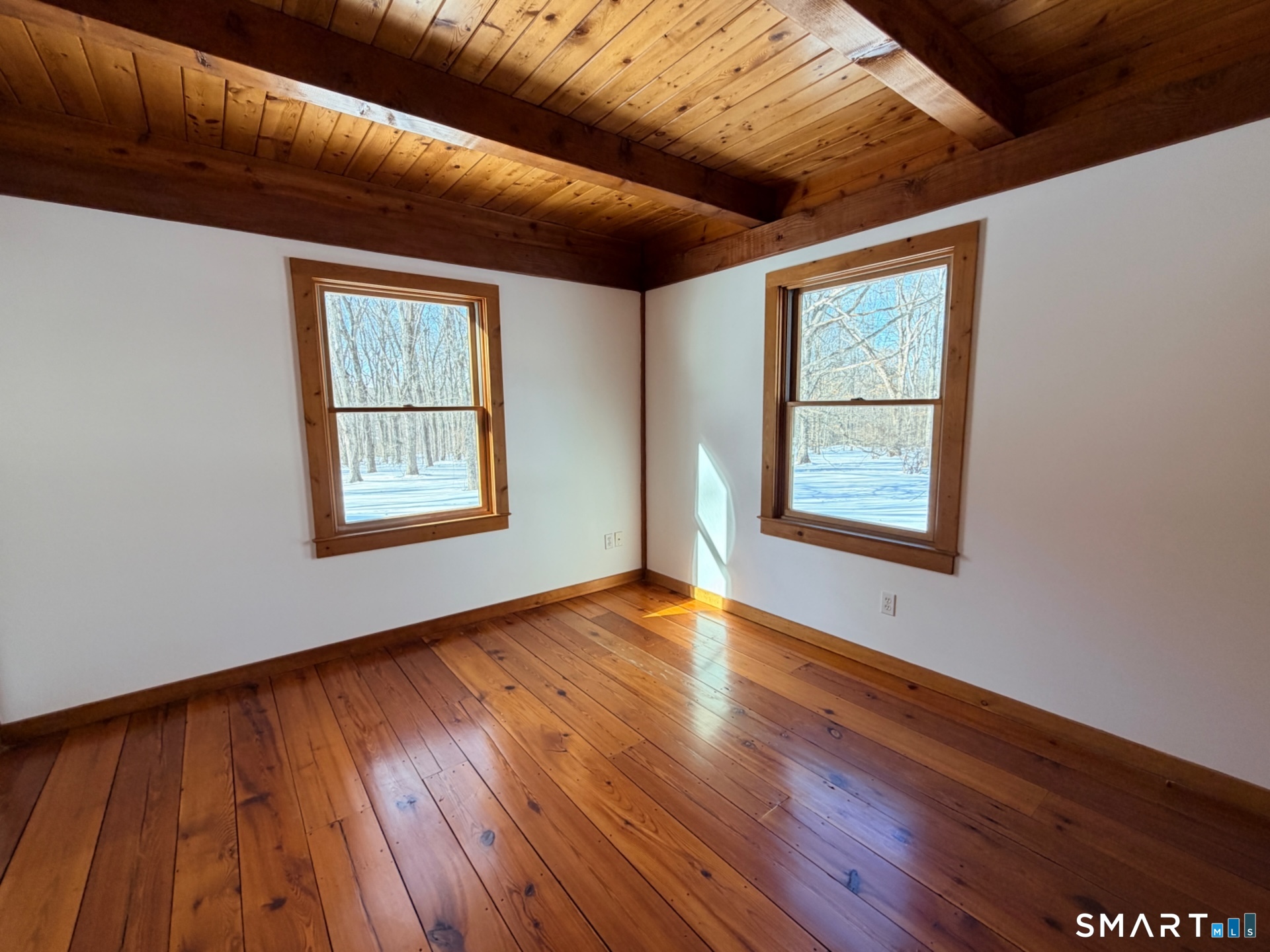 249 Woodbury Road Washington, CT 06793 - Photo 14 of 23 a view of an empty room with wooden floor and a window