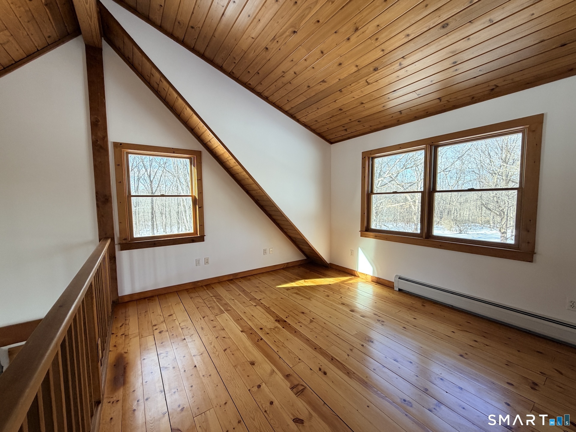 249 Woodbury Road Washington, CT 06793 - Photo 16 of 23 a view of an empty room with wooden floor and a window