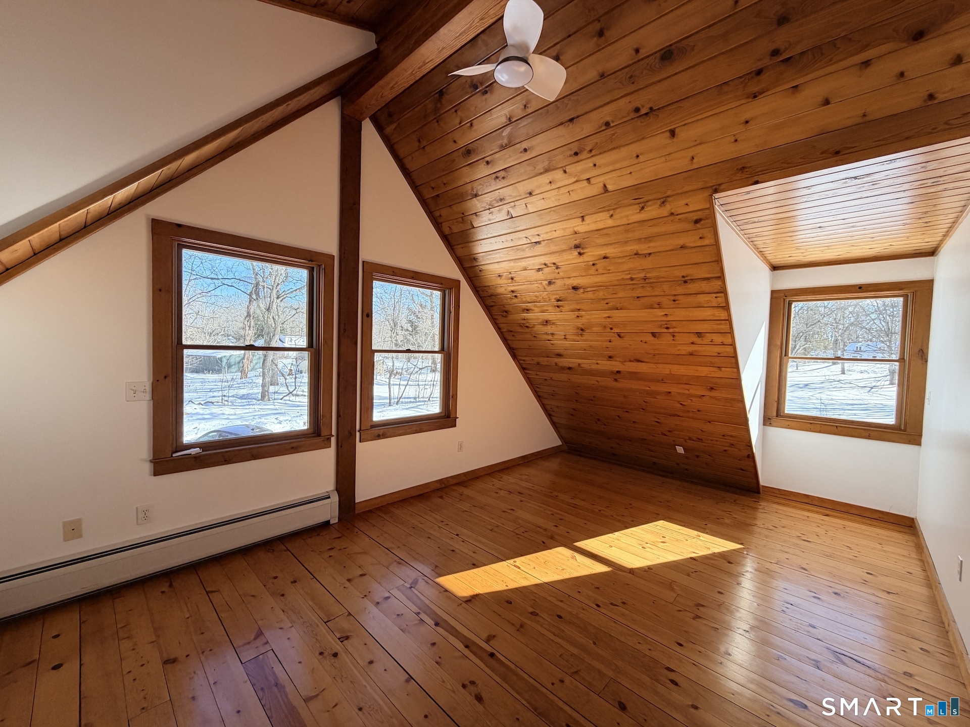 249 Woodbury Road Washington, CT 06793 - Photo 19 of 23 an empty room with wooden floor and windows