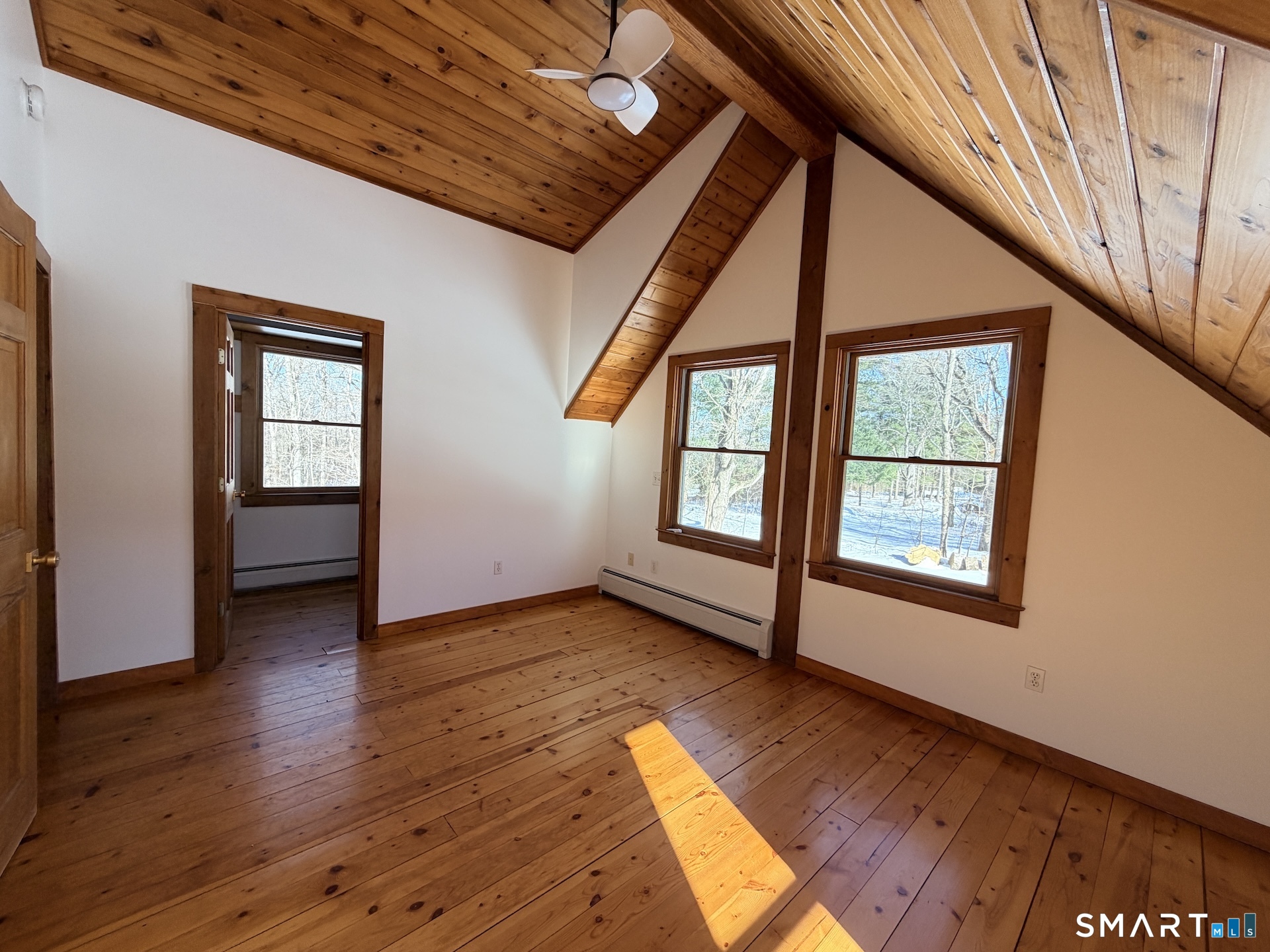 249 Woodbury Road Washington, CT 06793 - Photo 20 of 23 an empty room with wooden floor and windows