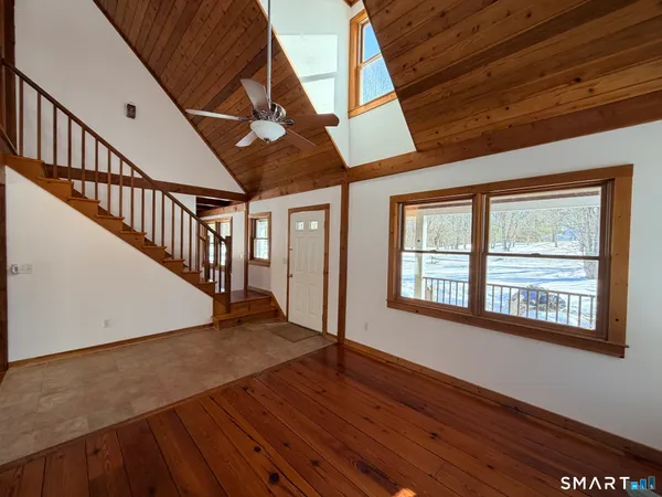 a view of an entryway with wooden floor